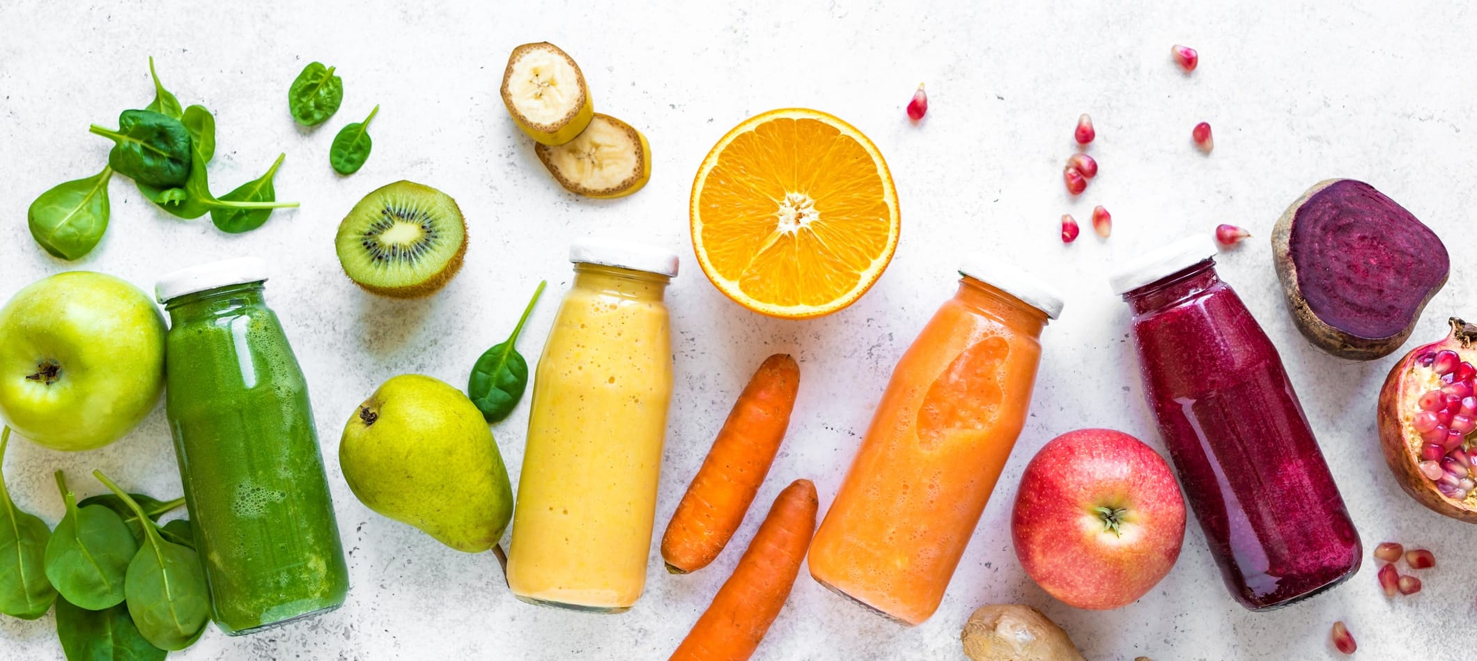 Various smoothies bottles and ingredients